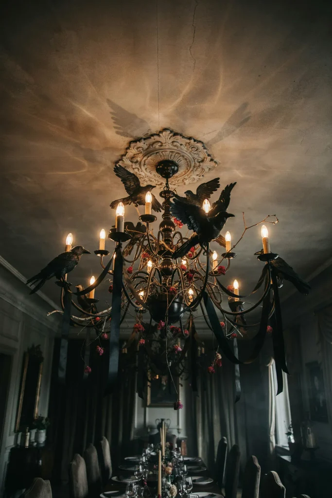 21 Gothic Halloween Decor Ideas for a Haunting 2026 16 Raven Chandelier Accents