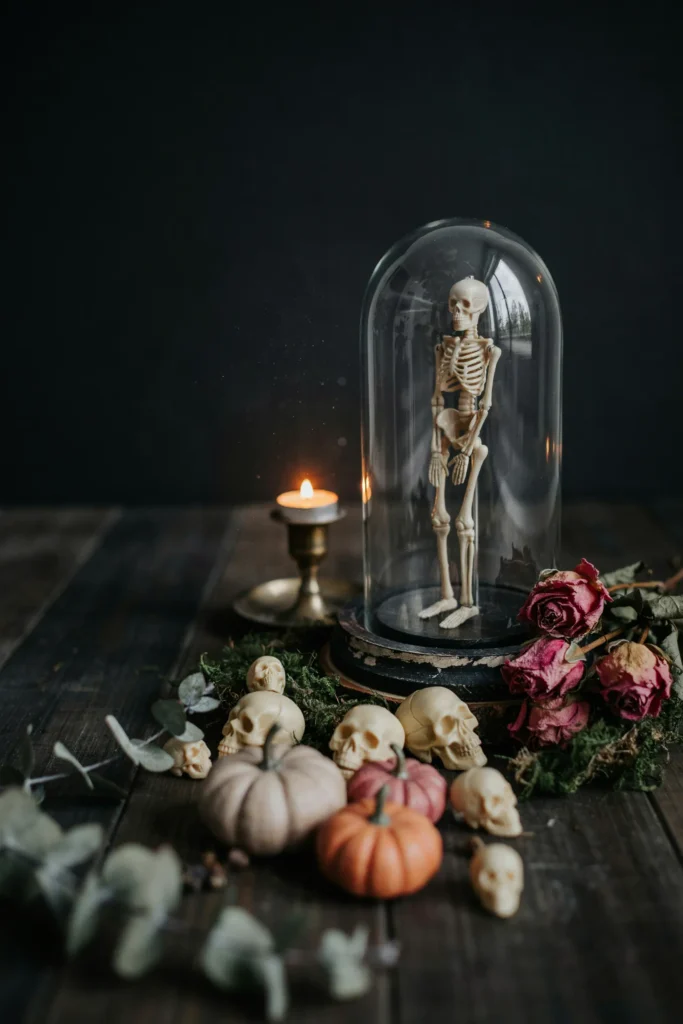 21 Skeleton Halloween Decor Ideas for a Chilling 2026 17 Skeleton Under Glass Cloche